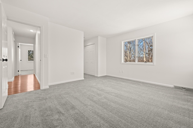 carpeted spare room featuring plenty of natural light