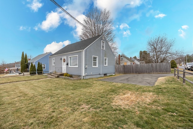 view of side of home featuring a patio area and a yard