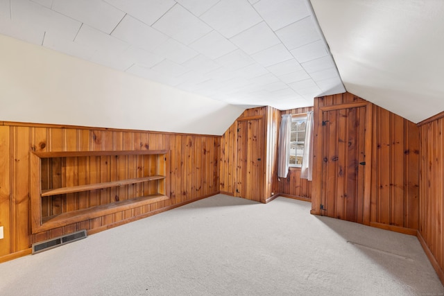 bonus room featuring light colored carpet and lofted ceiling