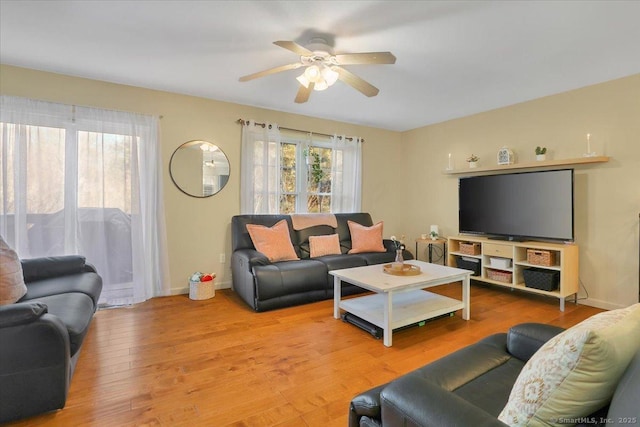 living room with hardwood / wood-style flooring, ceiling fan, and a healthy amount of sunlight