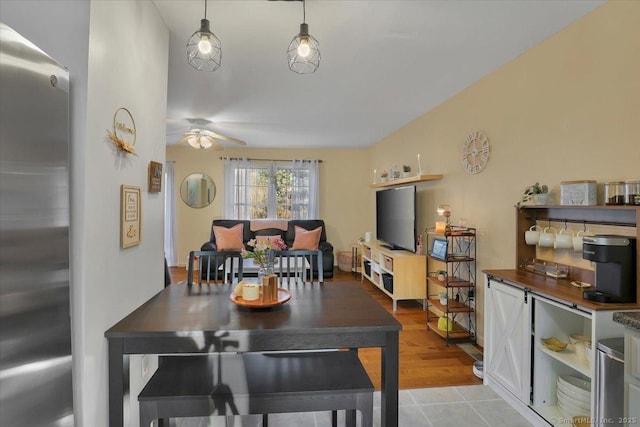 tiled dining room with ceiling fan