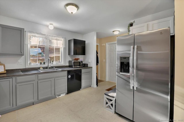 kitchen featuring sink, gray cabinetry, and stainless steel appliances