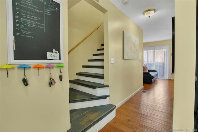 stairway featuring hardwood / wood-style flooring