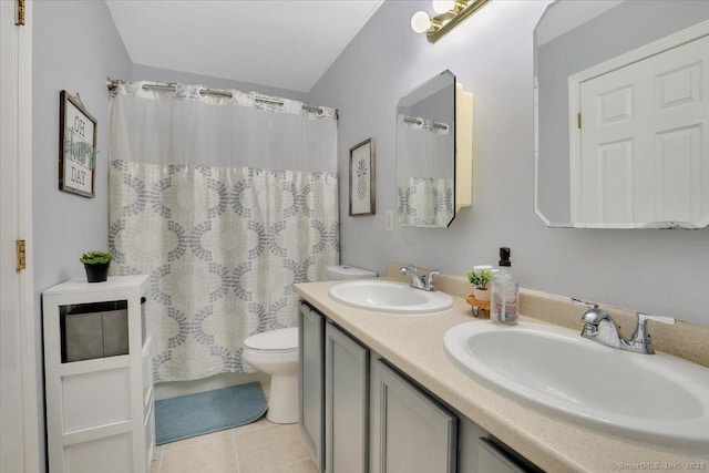 bathroom with toilet, vanity, a shower with shower curtain, and tile patterned flooring