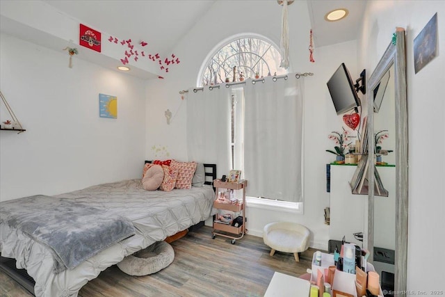 bedroom with vaulted ceiling and hardwood / wood-style floors