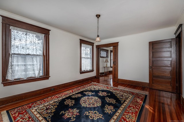 dining space with baseboards and hardwood / wood-style floors