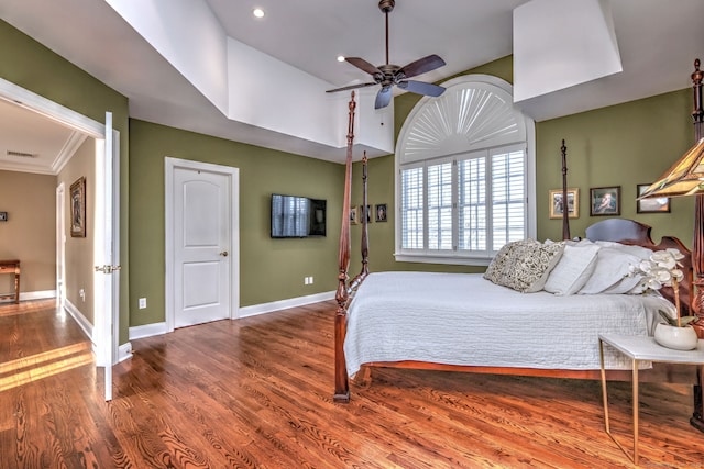 bedroom with ceiling fan, lofted ceiling, hardwood / wood-style floors, and ornamental molding