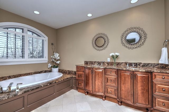 bathroom featuring vanity and a washtub