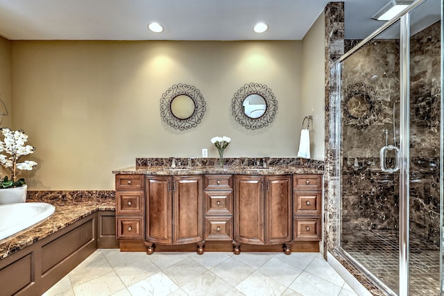 bathroom with vanity and independent shower and bath