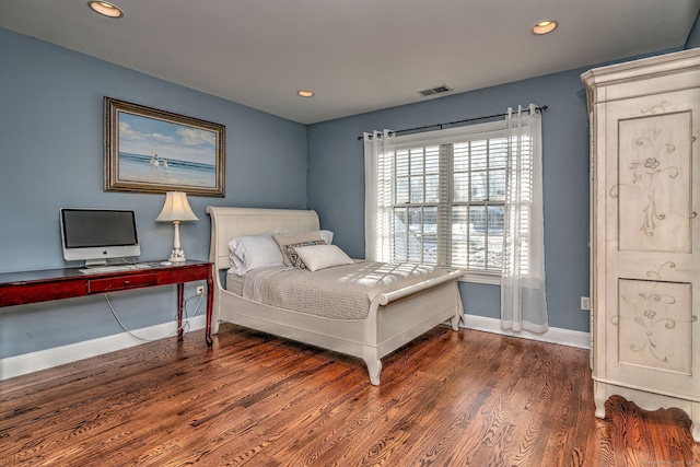 bedroom with dark wood-type flooring