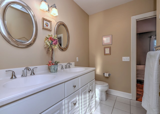 bathroom featuring tile patterned floors, toilet, and vanity