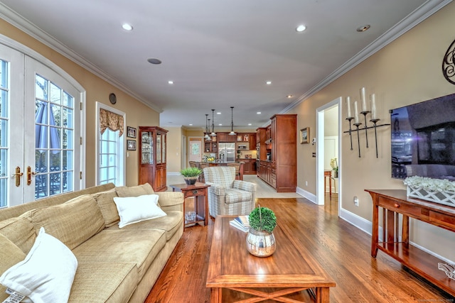 living room with wood-type flooring, crown molding, and french doors