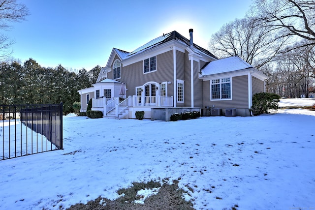 snow covered property featuring a wooden deck