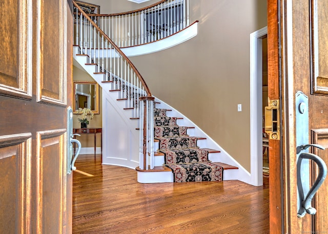 entryway featuring dark hardwood / wood-style flooring and a high ceiling