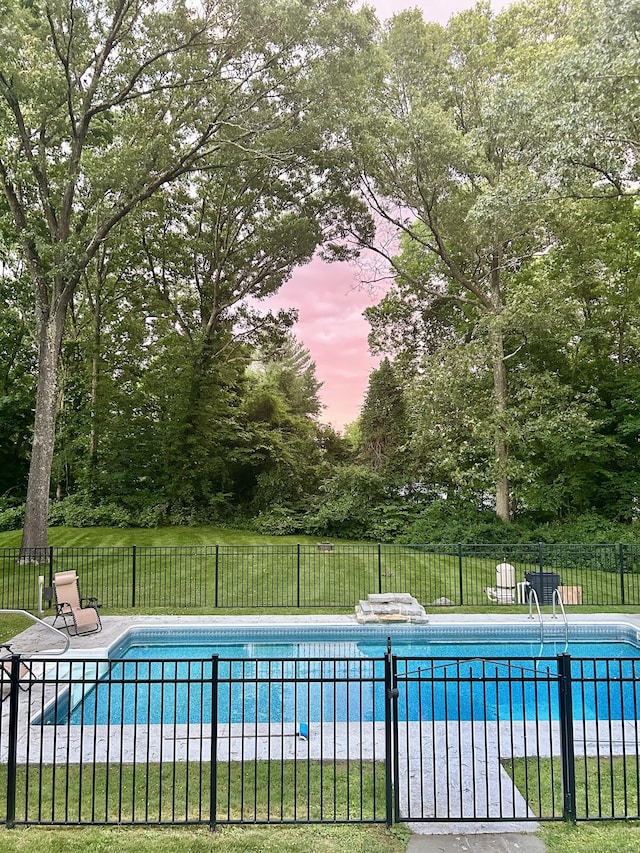 pool at dusk with a yard