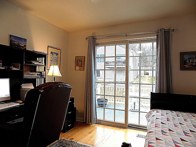 bedroom with access to exterior and light wood-type flooring