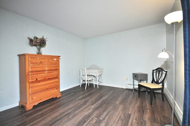 sitting room featuring a baseboard heating unit, wood finished floors, and baseboards