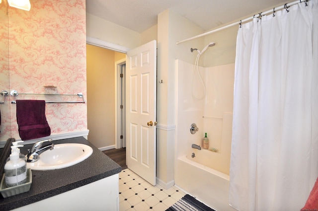 bathroom featuring shower / tub combo and vanity