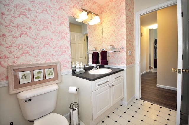 bathroom featuring vanity, tile patterned floors, toilet, and wallpapered walls