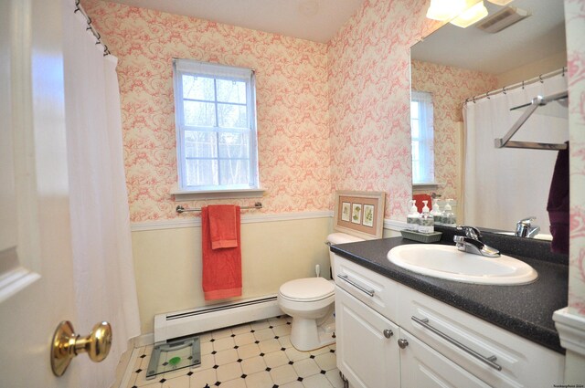 bathroom featuring vanity, baseboard heating, and toilet