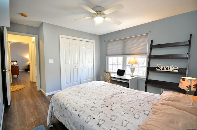 bedroom featuring a closet, dark wood finished floors, baseboards, and ceiling fan