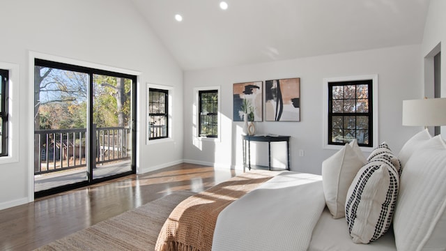 bedroom featuring wood-type flooring, access to exterior, and high vaulted ceiling