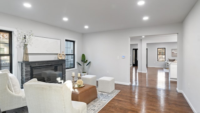 living room featuring dark hardwood / wood-style floors and a healthy amount of sunlight