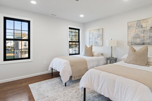 bedroom with dark hardwood / wood-style flooring