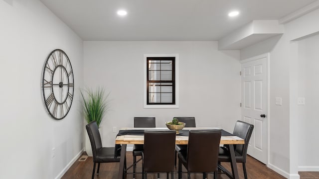 dining space featuring dark wood-type flooring