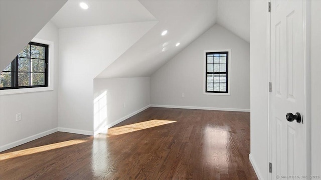 bonus room featuring lofted ceiling and dark hardwood / wood-style floors