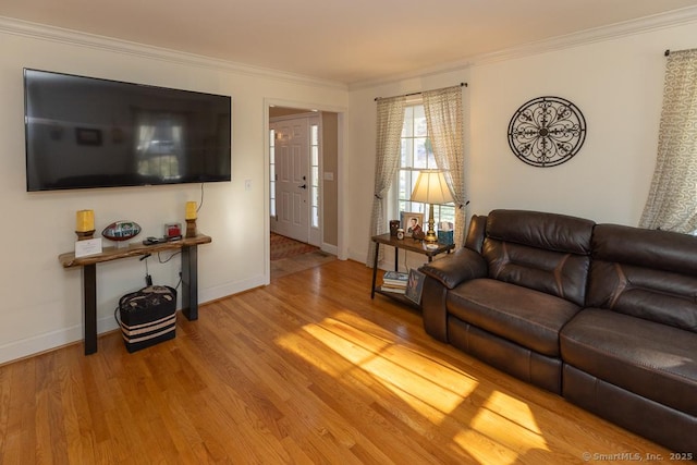 living room with ornamental molding, baseboards, and wood finished floors