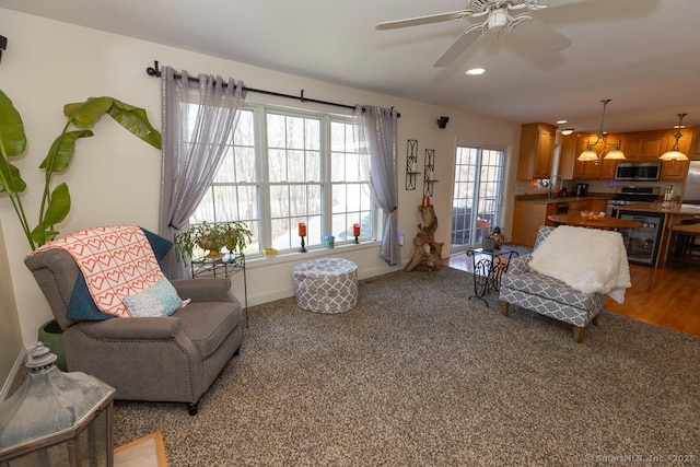 sitting room with wine cooler, recessed lighting, a ceiling fan, and baseboards