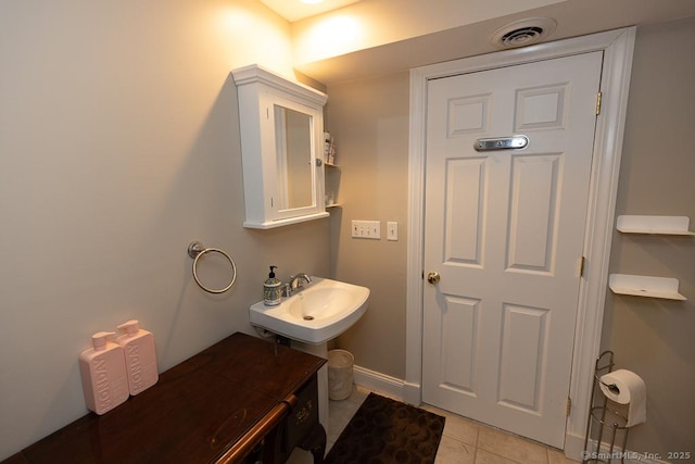 bathroom with visible vents, a sink, baseboards, and tile patterned floors