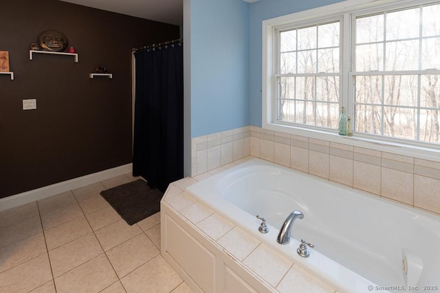 bathroom with curtained shower, tile patterned flooring, a bath, and baseboards