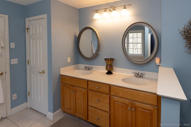 full bathroom featuring tile patterned floors, a sink, baseboards, and double vanity