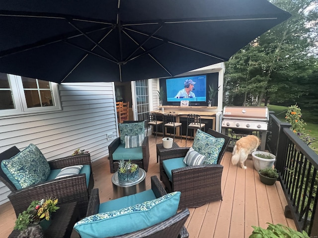 wooden deck featuring an outdoor living space and area for grilling