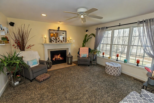 sitting room with dark colored carpet, recessed lighting, a ceiling fan, a tile fireplace, and baseboards