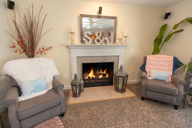 living area featuring carpet floors, a fireplace, and baseboards