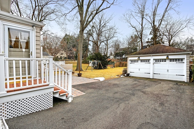 exterior space featuring a garage, an outdoor structure, and a playground