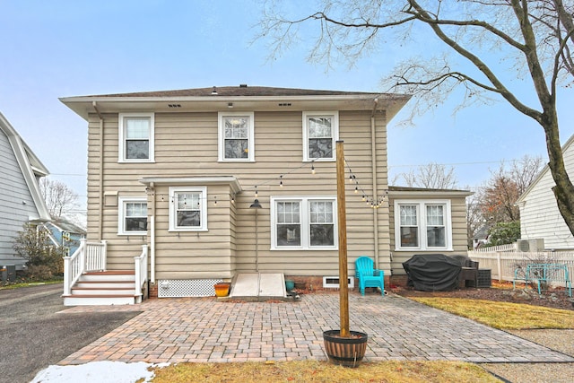 back of property with a patio