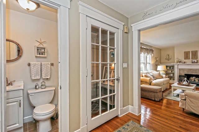 interior space with toilet, vanity, and hardwood / wood-style flooring