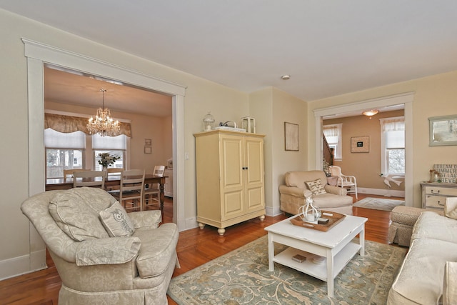 living room featuring dark hardwood / wood-style flooring and a notable chandelier