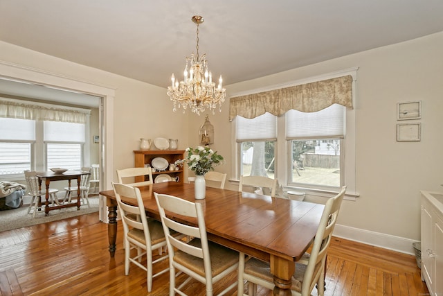 dining room featuring an inviting chandelier and hardwood / wood-style flooring