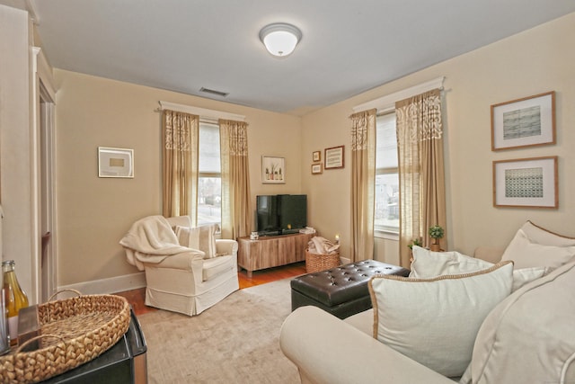 living room with plenty of natural light and wood-type flooring