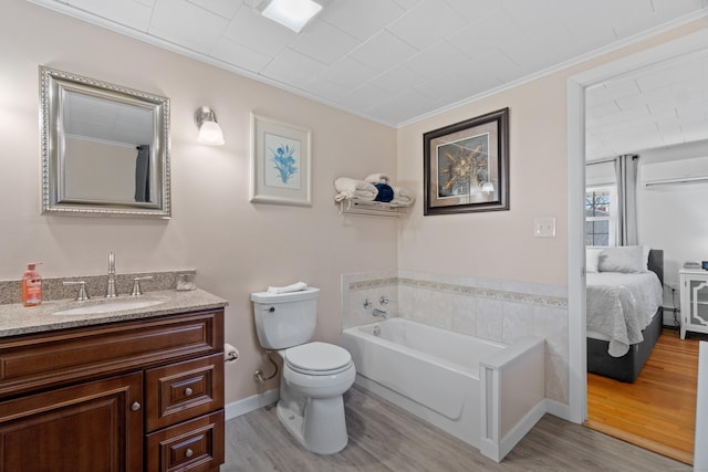 full bath with ensuite bathroom, a garden tub, wood finished floors, and vanity