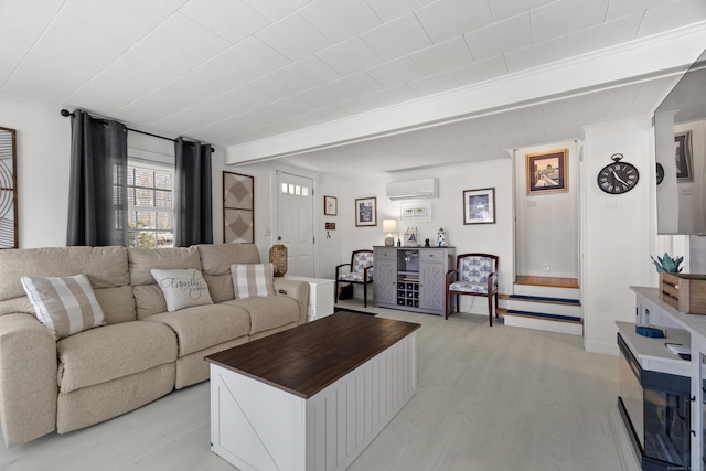 living area featuring a wall unit AC and light wood finished floors