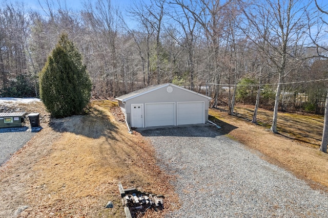 detached garage with a forest view