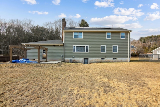 rear view of house featuring central air condition unit, a patio area, and a yard