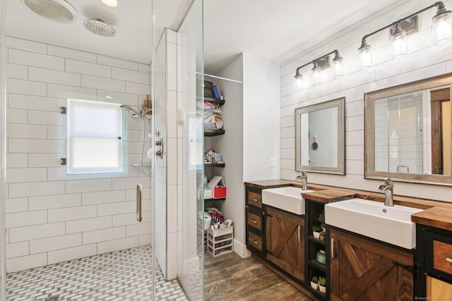 bathroom featuring vanity and a shower with door