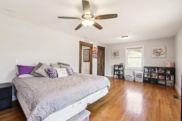 bedroom with ceiling fan and hardwood / wood-style floors